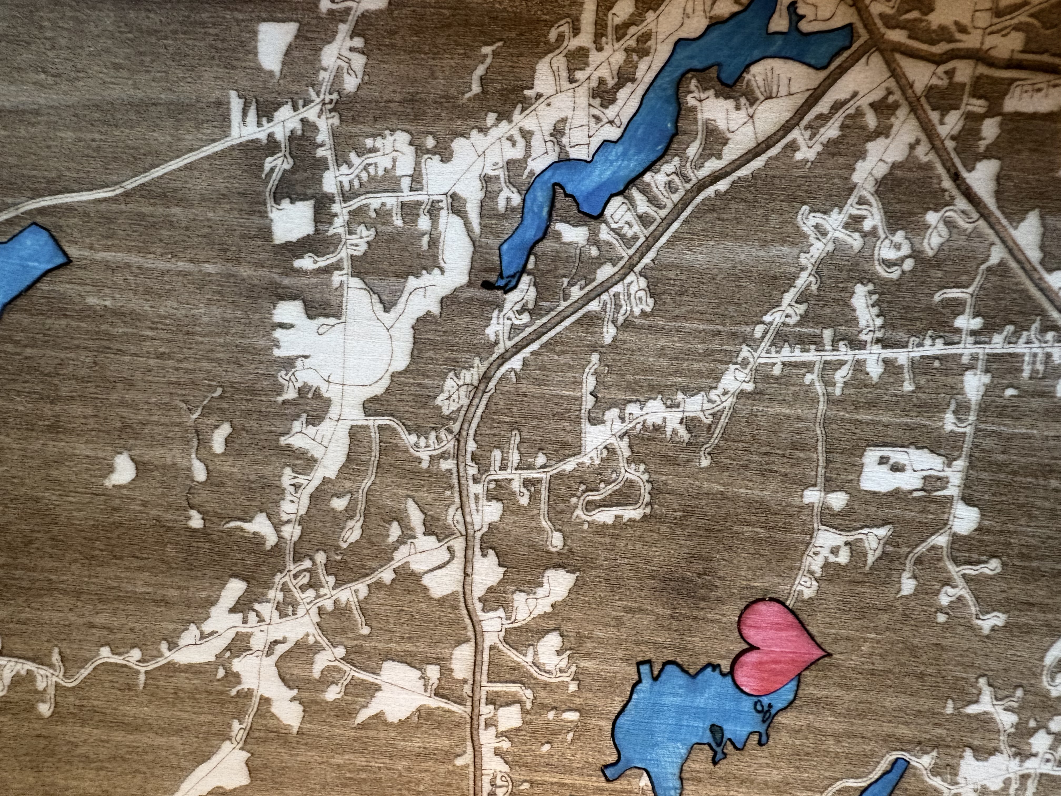 Laser-cut wooden cabin map with location marker