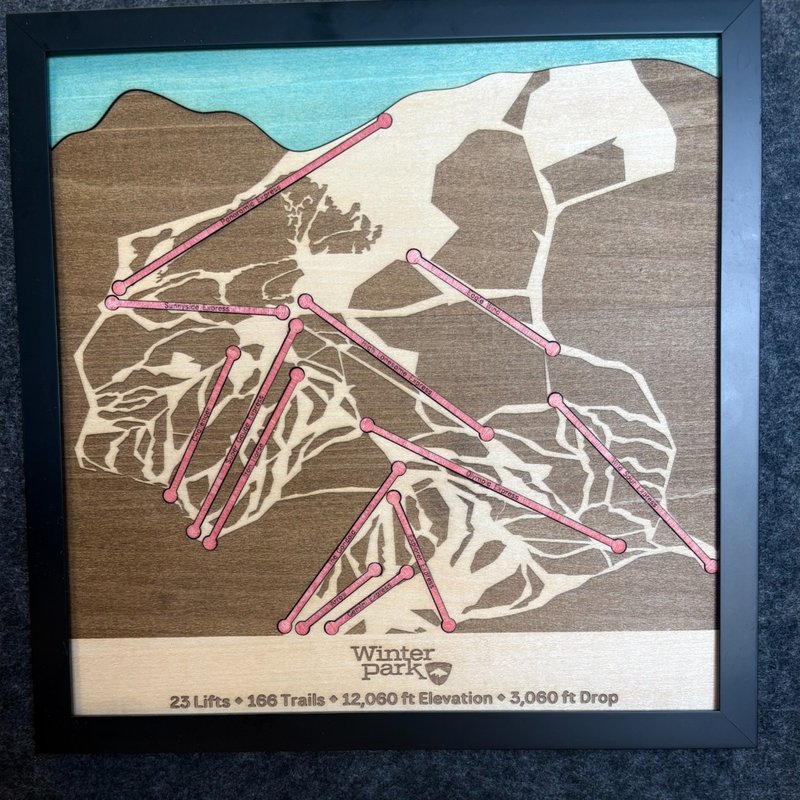 Laser-cut wooden ski resort map with ski trails and lifts